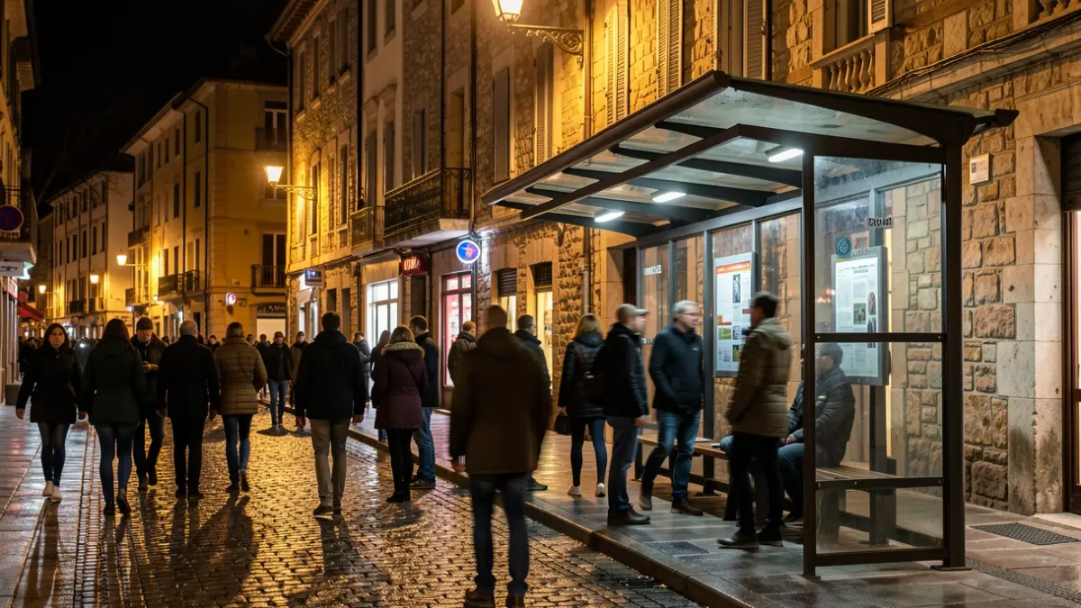 Generic image of a busy bus stop at night in Perpignan, with warm lights and blurred silhouettes.