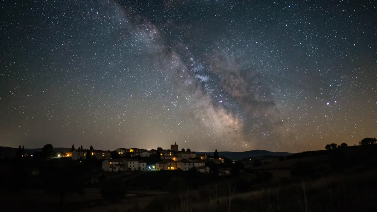 Generic image of a starry night sky over a town silhouette, evoking wonder.